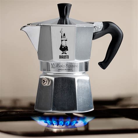 The iconic Bialetti Moka Express for 8 cups, silver or black color, on a kitchen counter.