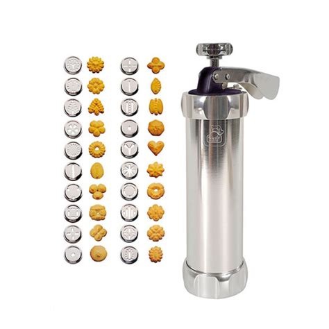 Testomat za piškote z razstavljenimi nastavki in matricami.