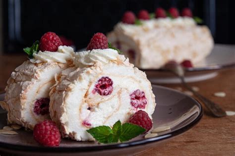 Thematic photo of a meringue roll with mascarpone, white chocolate and raspberries