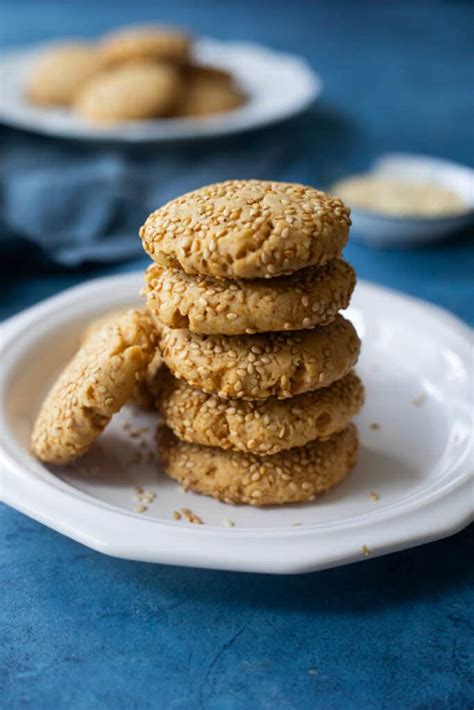 Photo of finished rice flour tahini cookies with a spoonful of date caramel in the center.