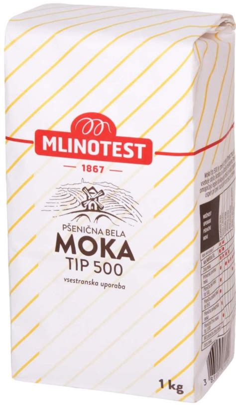 Fotografija: Pšenična moka tip 400 v posodi, ob njej piškoti/biskvit