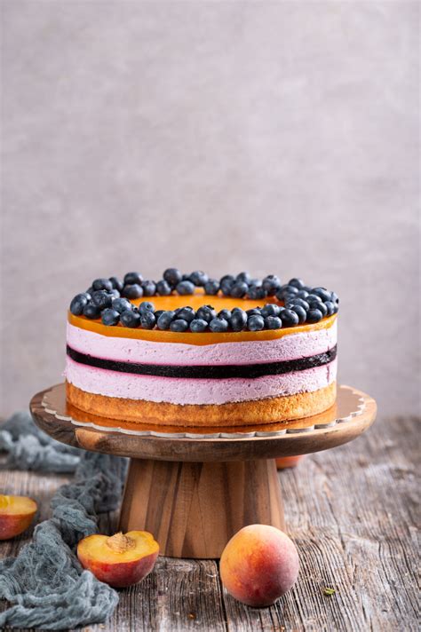 Fotografija skutne torte z breskvami, ki prikazuje njeno svežino in poletni videz.