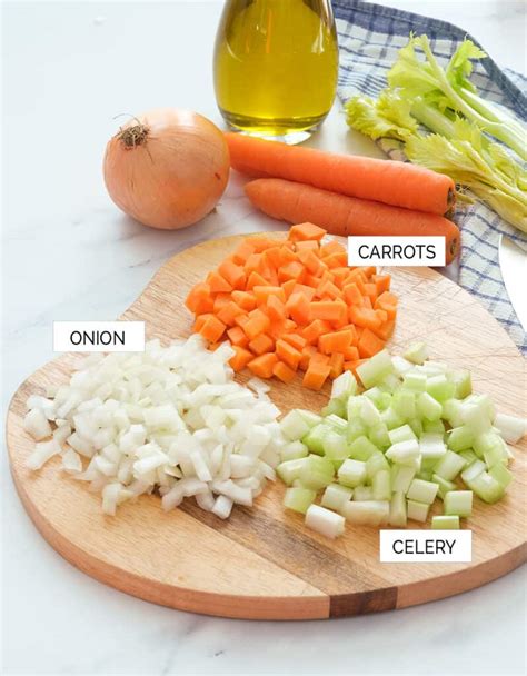 Infographic illustrating the soffritto process: finely chopped onion, carrot, and celery slowly caramelizing in olive oil.