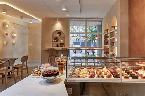 Thematic photo of a modern pastry shop interior with various cakes and desserts on display.
