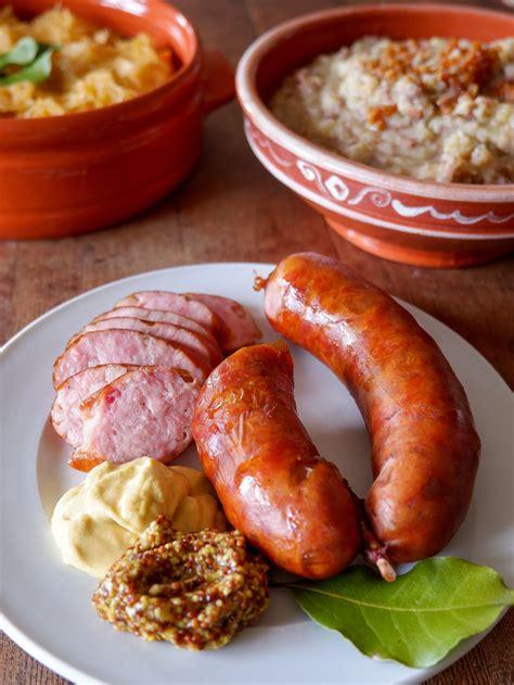 Thematic photo of a cooked Kranjska klobasa served with mustard and horseradish