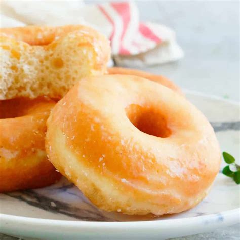 Thematic photo of fluffy, golden-brown doughnuts with a light ring, and a separate image of greasy, heavy doughnuts