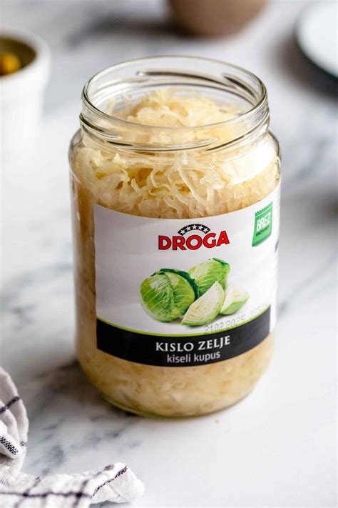 Stekleni kozarci napolnjeni s kislim zeljem, pripravljeni za fermentacijo