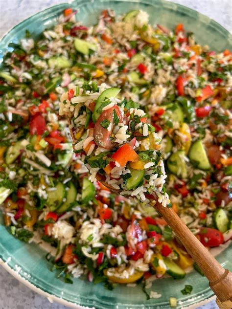 Thematic photo of a colorful cold rice salad on a summer table