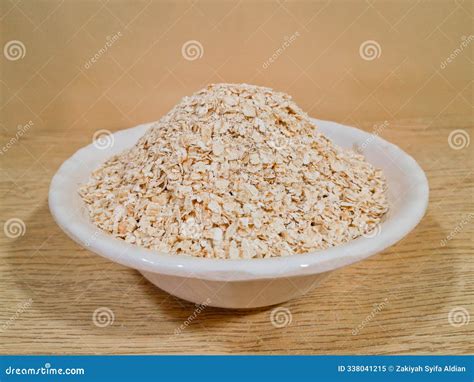 Thematic photo of oat grains and oat flakes in a bowl