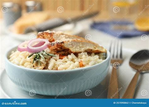 Thematic photo of a rustic, home-style sticky chicken risotto served in a bowl