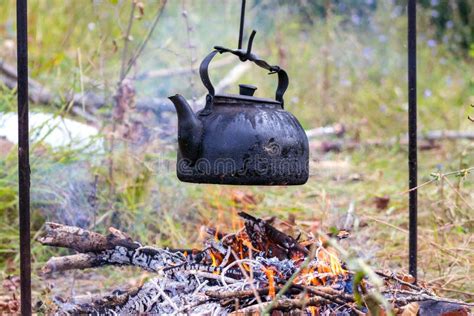 Thematic photo of a kettle on a tripod over an open fire