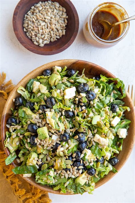 Photo of a vibrant salad topped with roasted sunflower seeds, showcasing a practical culinary use.