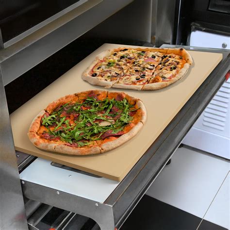 Photo of a pizza baking in a hot oven on a pizza stone