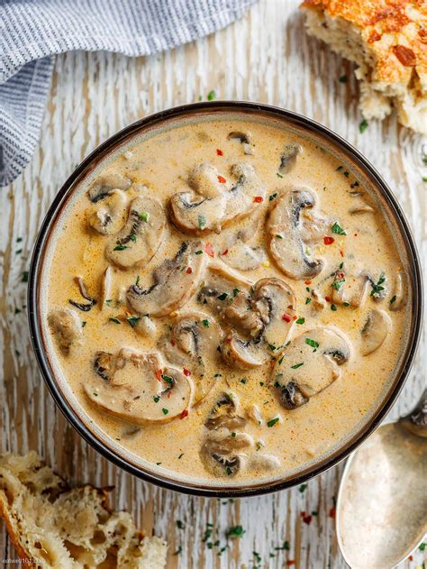 Thematic photo of a bowl of creamy mushroom soup with fresh parsley