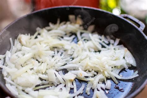 Thematic photo of chopped onions in a frying pan.