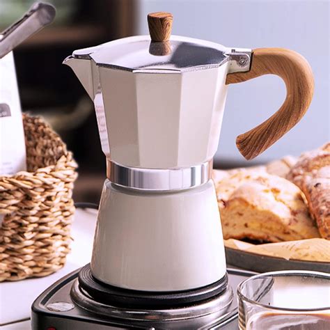 Thematic photo of an electric Moka pot brewing coffee on a kitchen counter