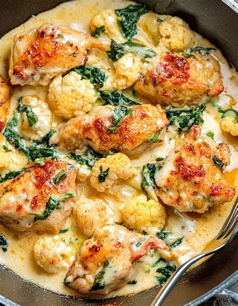 The final dish of cauliflower and chicken with egg cheese, garnished with fresh oregano and butter slices