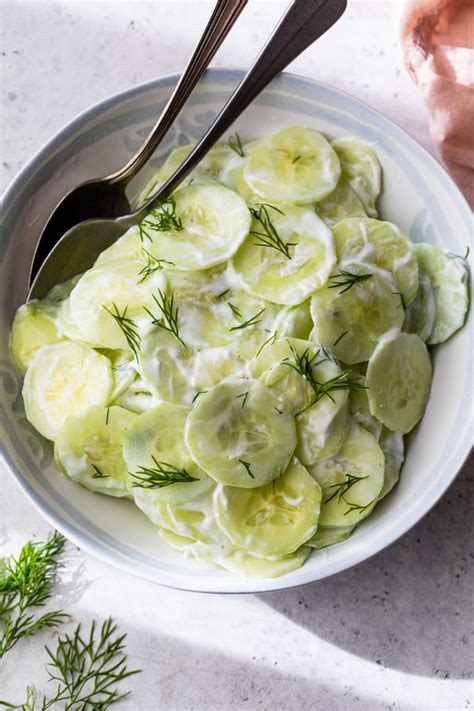 Thematic photo of fresh cucumber salad with dill and coconut yogurt in a bowl