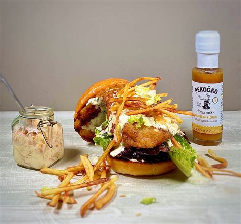 Pripravljen fish burger s tatarsko omako in solato.