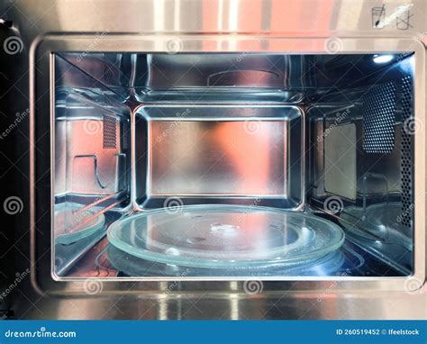 Thematic photo of a modern microwave oven with a plate of fries inside