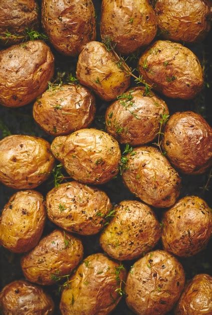 A plate with baked whole potatoes, ready to be served