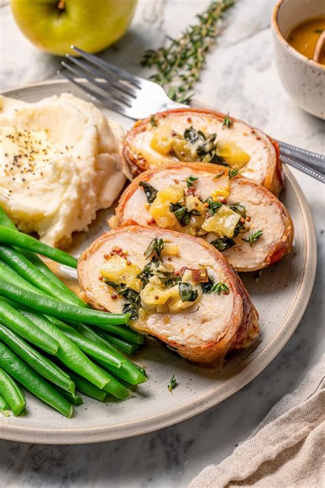 Thematic photo of sliced stuffed turkey cutlets with prosciutto and cheese, served with side dish