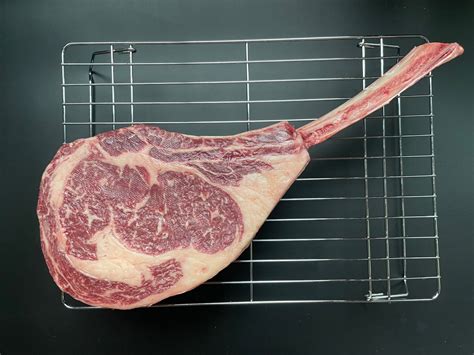 Thematic photo of raw Tomahawk steak at room temperature