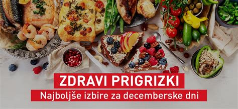 Različni zdravi prigrizki v manjših posodah, kot so sadje, zelenjavne palčke in oreščki