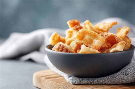 Thematic photo of golden-brown pork cracklings in a bowl