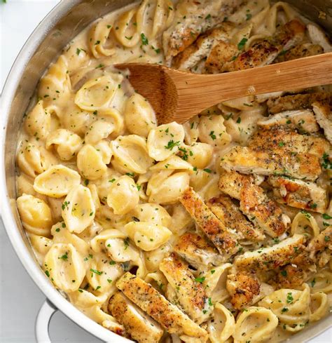 Thematic photo of chicken in cream sauce with pasta in a pan