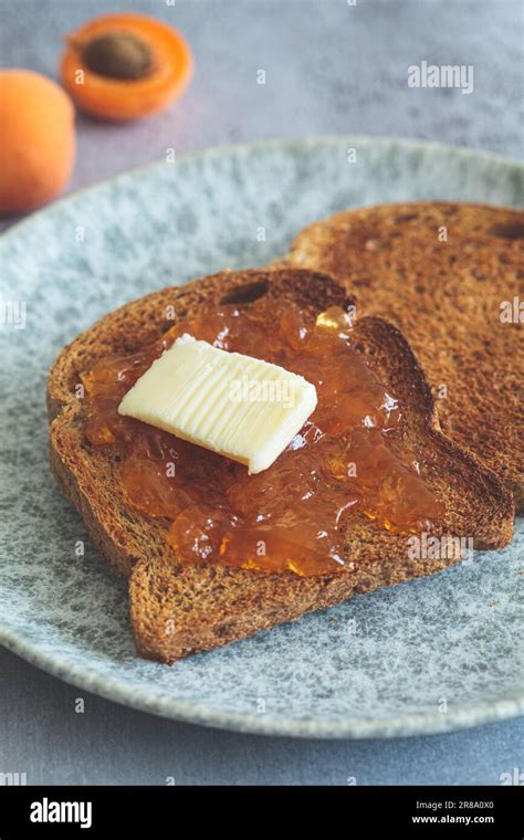 Thematic photo of apricot jam on toast with butter