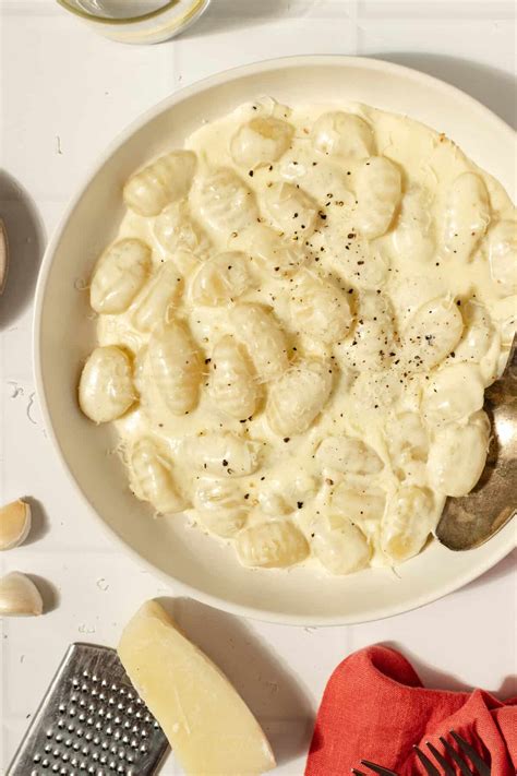 Thematic photo of white sauce with prosciutto and gnocchi