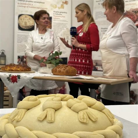 Ilustracija tradicionalnega božičnega kruha Stollen, okrogle oblike z posipom sladkorja v prahu.