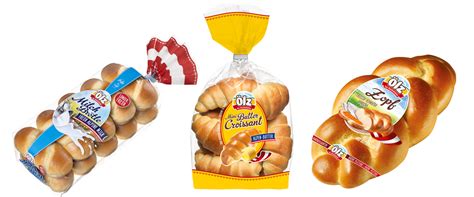 assortment of Ölz breakfast products, including milk rolls, braids, and croissants