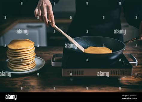 Thematic photo of a person making pancakes on a high-quality pan