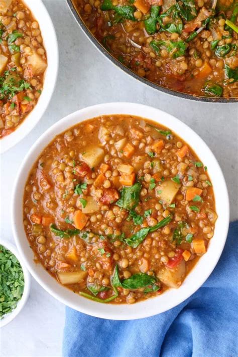 Healthy lentil stew with vegetables and slices of sausage