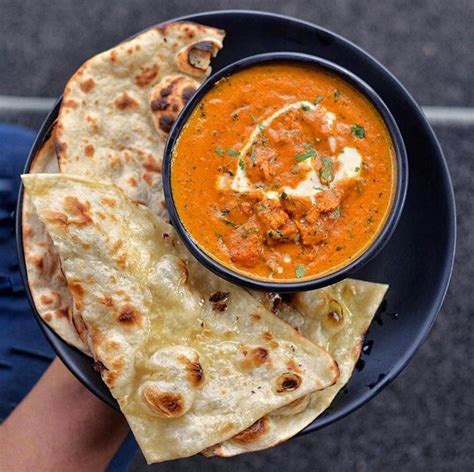 Thematic photo of Indian Butter Chicken with naan bread