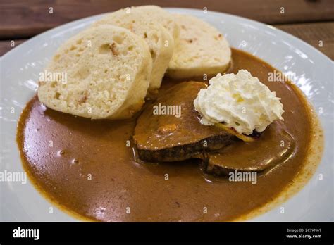 Thematic photo of bread dumplings on a plate with meat and sauce