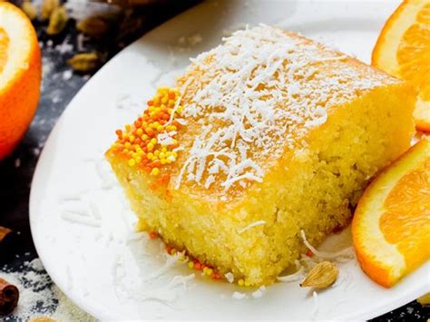 Thematic photo of a moist semolina coconut cake with orange syrup, garnished with sesame seeds