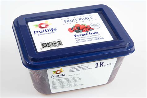 Photo of a vibrant, smooth forest fruit puree in a small saucepan