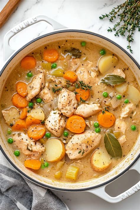 Thematic photo of chicken stew in a bowl with fresh herbs