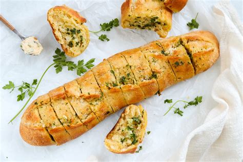 Thematic photo of a freshly baked baguette with herbs
