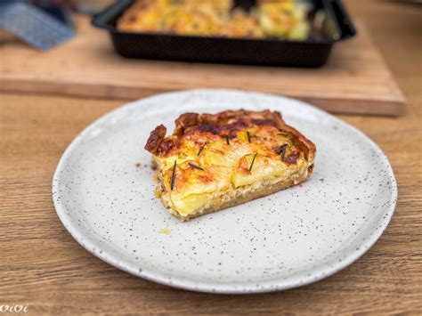 Thematična fotografija: Cvetačna pita s sirom in čebulo, postrežena na krožniku.