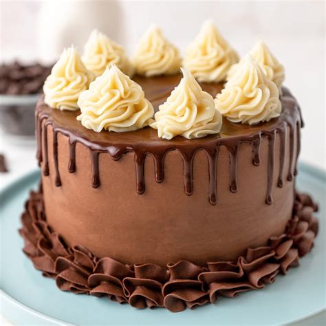 Photo of a cake decorated with whipped white chocolate ganache