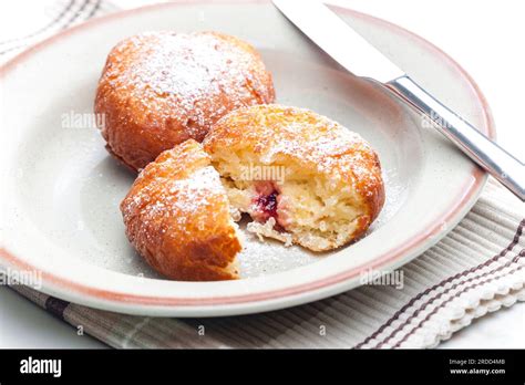 Thematic photo of a donut being filled with marmalade.