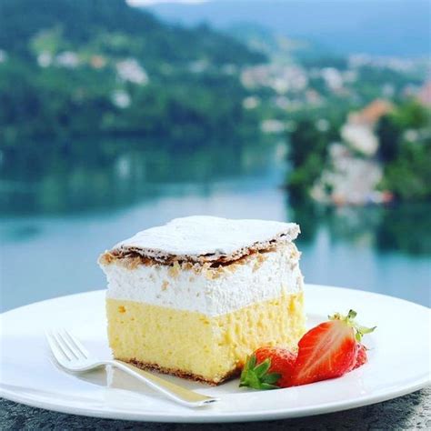 The iconic Bled cream cake with Lake Bled and island in the background