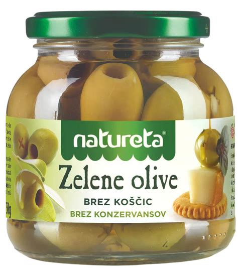 slika vanilijevega kompota Natureta brez koščic, ki je postrežen v stekleni posodi s sladko smetano in okroglim piškotom ob boku