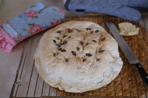 Ilustracija sveže pečenega domačega kruha s sezamom, posipanega z dodatnimi sezamovimi semeni.