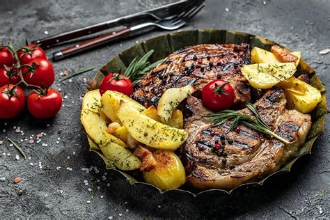 fotografija pečene svinjine na žaru, postrežene s prilogo