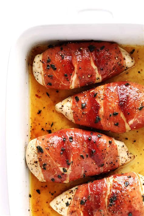 Thematic photo of cooked chicken breasts wrapped in prosciutto, served on a plate